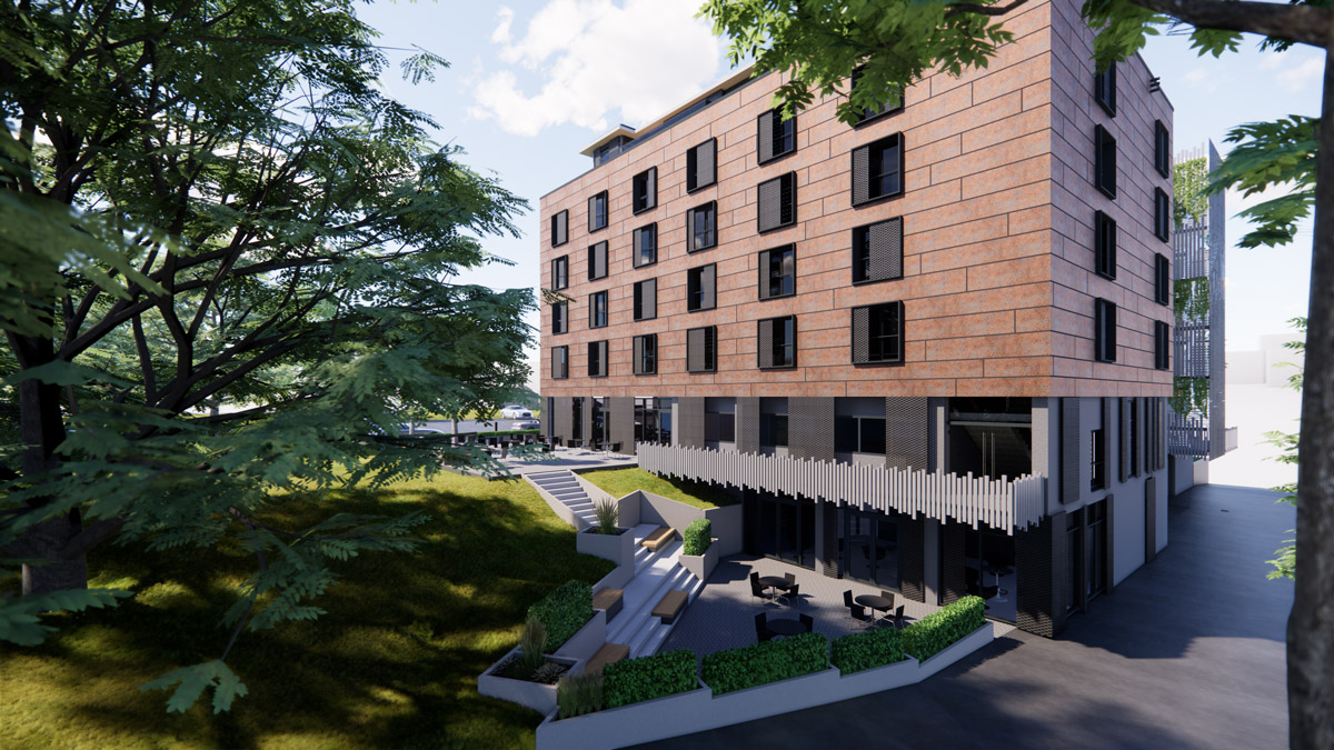 Modernes mehrstoeckiges Backsteingebaeude mit Terrasse und gruener Umgebung
